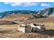 Expansive aerial view of luxurious homes surrounded by rolling hills and scenic landscapes at 5741 Doc Bar Circle, Larkspur, CO 80118