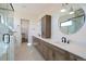 A bright bathroom with a double sink vanity, sleek fixtures, modern lighting and a glass-enclosed shower at 5741 Doc Bar Circle, Larkspur, CO 80118