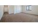 A spacious bedroom with carpet flooring featuring closet with sliding doors at 5741 Doc Bar Circle, Larkspur, CO 80118