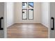 Bright, empty bedroom with hardwood floors and large windows offering plenty of natural light at 5741 Doc Bar Circle, Larkspur, CO 80118
