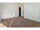 A bedroom features neutral walls and carpet as well as a closet with double doors at 5741 Doc Bar Circle, Larkspur, CO 80118
