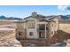 Elegant two-story home with a stone-clad facade, large windows, and a charming balcony at 5741 Doc Bar Circle, Larkspur, CO 80118