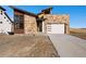 Stunning exterior elevation showcasing a modern home with stone accents and a concrete driveway at 5741 Doc Bar Circle, Larkspur, CO 80118