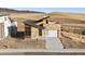 Beautiful home featuring a stone facade, modern garage door, and sleek architectural design at 5741 Doc Bar Circle, Larkspur, CO 80118