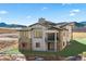 Stunning home showcases large windows, stone accents, a balcony and surrounding mountain views at 5741 Doc Bar Circle, Larkspur, CO 80118