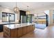 Gourmet kitchen featuring a spacious island, premium appliances, and seamless access to outdoor deck at 5741 Doc Bar Circle, Larkspur, CO 80118