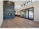 Bright living room featuring a stone fireplace, hardwood floors, and large sliding glass doors at 5741 Doc Bar Circle, Larkspur, CO 80118