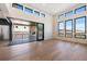 Modern living room with a stone fireplace on the patio and breathtaking views from expansive windows at 5741 Doc Bar Circle, Larkspur, CO 80118