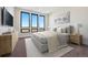 A bedroom featuring a bed, dresser, wall art, and bright natural light from the windows, creating a serene atmosphere at 5741 Doc Bar Circle, Larkspur, CO 80118