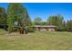 Large backyard featuring a playground and manicured lawn at 4500 S Dasa Dr, Cherry Hills Village, CO 80111