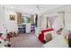 Charming bedroom with a canopy bed, colorful curtains, and built-in bookshelves at 4500 S Dasa Dr, Cherry Hills Village, CO 80111