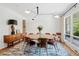 Modern dining room with large table, stylish light fixture, and hardwood floors at 4500 S Dasa Dr, Cherry Hills Village, CO 80111