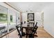 Dining room with a dark wood table, black chairs, and sliding glass doors to the patio at 4500 S Dasa Dr, Cherry Hills Village, CO 80111