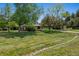 Well-manicured front yard with mature trees providing shade at 4500 S Dasa Dr, Cherry Hills Village, CO 80111