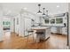 Modern white kitchen with a center island, stainless steel appliances, and hardwood floors at 4500 S Dasa Dr, Cherry Hills Village, CO 80111