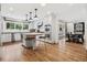 Bright kitchen with stainless steel appliances, center island with bar seating, and hardwood floors at 4500 S Dasa Dr, Cherry Hills Village, CO 80111