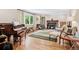 Cozy living room featuring hardwood floors, a fireplace, and a piano at 4500 S Dasa Dr, Cherry Hills Village, CO 80111