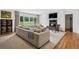 Spacious living room with a fireplace, large sectional sofa, and sliding doors to the backyard at 4500 S Dasa Dr, Cherry Hills Village, CO 80111
