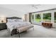 Calming main bedroom with large windows overlooking the backyard and a seating bench at 4500 S Dasa Dr, Cherry Hills Village, CO 80111