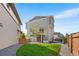 Beautiful backyard featuring a well-manicured lawn, gravel area, and a modern home exterior at 16362 E 111Th Dr, Commerce City, CO 80022