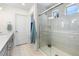Updated bathroom boasting dual vanities, a glass-enclosed shower, and stylish tile work, offering a spa-like experience at 16362 E 111Th Dr, Commerce City, CO 80022