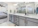 Elegant bathroom with dual vanities, modern fixtures, and a glass-enclosed shower providing a luxurious and functional space at 16362 E 111Th Dr, Commerce City, CO 80022