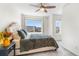 Comfortable bedroom featuring a ceiling fan, and large windows offering natural light, creating a restful retreat at 16362 E 111Th Dr, Commerce City, CO 80022