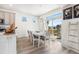 Bright dining area with large windows, stylish furnishings, and easy access to outdoor space at 16362 E 111Th Dr, Commerce City, CO 80022