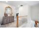 Upstairs hallway featuring an ornate mirror and stylish decor creating an inviting transition between rooms at 16362 E 111Th Dr, Commerce City, CO 80022