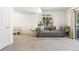 Cozy living room with a large window, comfortable gray sofa, and neutral-toned walls and carpeting at 16362 E 111Th Dr, Commerce City, CO 80022