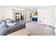 Inviting living room featuring a comfortable gray sofa, bright windows, and a sliding glass door to the outdoors at 16362 E 111Th Dr, Commerce City, CO 80022