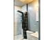 Compact bathroom featuring modern shower with rainfall head and handheld sprayer, white tiles, and efficient layout at 3325 Navajo St, Denver, CO 80211