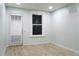 Bright bedroom with wood floors, white trim, and a door and window providing natural light and access at 3325 Navajo St, Denver, CO 80211