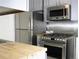 Kitchen area featuring stainless steel appliances, including refrigerator, gas range, and microwave at 3325 Navajo St, Denver, CO 80211