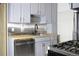 Efficient kitchen layout featuring stainless steel appliances, light gray cabinets, and gas range for cooking convenience at 3325 Navajo St, Denver, CO 80211