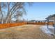 Suburban backyard with dry grass and a high wooden fence at 6431 W 77Th Pl, Arvada, CO 80003