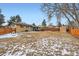 Large suburban backyard with a high wooden fence and detached shed at 6431 W 77Th Pl, Arvada, CO 80003