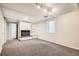 Spacious basement with a classic fireplace, built in cabinets and shelving and modern carpet at 6431 W 77Th Pl, Arvada, CO 80003