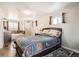 This bedroom includes great natural light and a bathroom with a tub and tiled shower at 6431 W 77Th Pl, Arvada, CO 80003