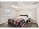 Cozy bedroom with a queen bed, soft carpet and natural light from the basement window at 6431 W 77Th Pl, Arvada, CO 80003