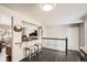 Inviting dining area featuring a breakfast bar with seating and an open layout leading to the living room at 6431 W 77Th Pl, Arvada, CO 80003