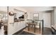 Bright dining area with modern furnishings and open access to the spacious living room with natural light at 6431 W 77Th Pl, Arvada, CO 80003