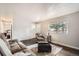 Inviting living room with wood floors, cozy seating, and a bright window for natural light at 6431 W 77Th Pl, Arvada, CO 80003