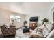 Cozy living room with neutral colors, plush furniture, and natural light from a bright window at 6431 W 77Th Pl, Arvada, CO 80003