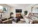 Comfortable living room featuring wood floors, ample seating, and a large window for natural light at 6431 W 77Th Pl, Arvada, CO 80003