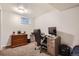 Functional home office featuring built-in desk, cabinets, and a bright basement window at 6431 W 77Th Pl, Arvada, CO 80003