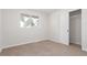 Neutral-toned bedroom with window view and closet at 416 Troy St, Aurora, CO 80011