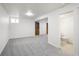 Spacious basement featuring neutral carpet and adjacent bathroom at 9338 W Utah Pl, Lakewood, CO 80232