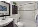 Cozy bathroom with white tile, vanity sink, tub, and modern fixtures at 9338 W Utah Pl, Lakewood, CO 80232