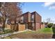 Attractive townhouse featuring brick facade, brown wood accents and a well-kept front lawn at 9338 W Utah Pl, Lakewood, CO 80232